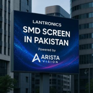 Digital billboard in a modern urban setting displaying the text "Lantronics SMD Screen in Pakistan – Powered by Arista Vision" with a blue tech-themed background, showcasing advanced display technology.